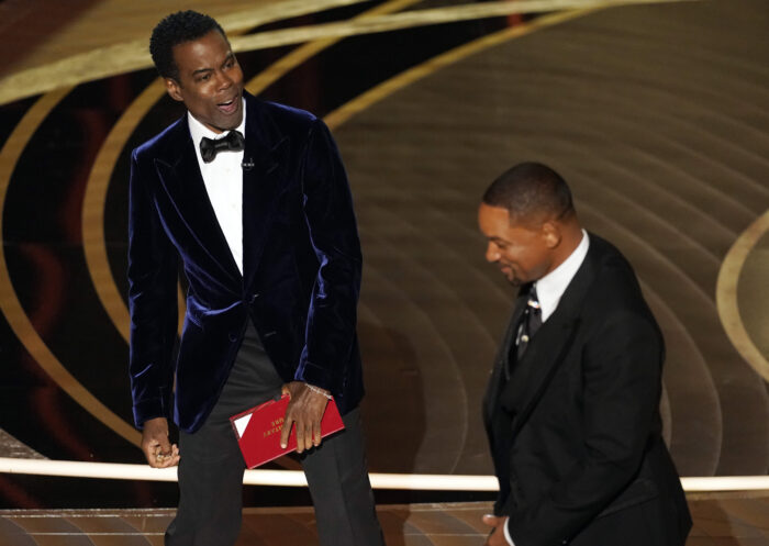 Presenter Chris Rock, left, reacts after Will Smith slapped him onstage at the Oscars, Sunday, March 27, 2022, at the Dolby Theatre in Los Angeles. (AP Photo/Chris Pizzello)