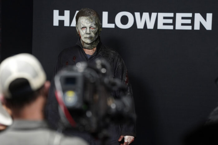 A man dressed as the killer character Michael Myers (aka The Shape) from the "Halloween" films looks on during the premiere of the film "Halloween Kills," Tuesday, Oct. 12, 2021, at the TCL Chinese Theatre in Los Angeles. (AP Photo/Chris Pizzello)